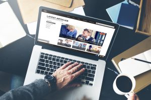 man typing on laptop